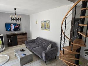 a living room with a couch and a staircase at Kali in Kukuljanovo
