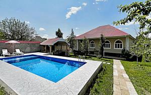 a swimming pool in the yard of a house at Courtyardqabala in Gabala