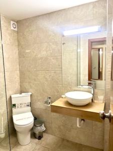 a bathroom with a toilet and a sink and a mirror at Hotel Perunika in Golden Sands +11 photos