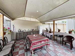 a patio with a table and chairs and a kitchen at Courtyardqabala in Gabala