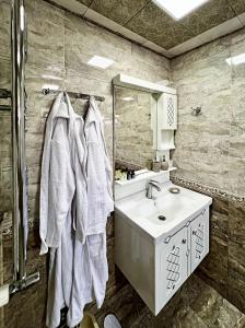 a bathroom with a sink and a mirror at Courtyardqabala in Gabala