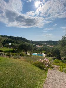 a view of a yard with a swimming pool at Pefkohori Suits in Pefkochori
