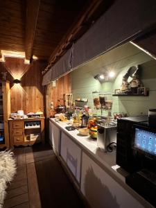 a kitchen with a counter with food on it at Hôtel-Chalet les Mélèzes in Valloire +56 photos