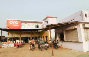 a group of motorcycles parked in front of a building at Hotel O Sunrise in Somna