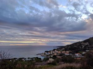 a town on a hill next to the ocean at La casa di Grace in Seccheto