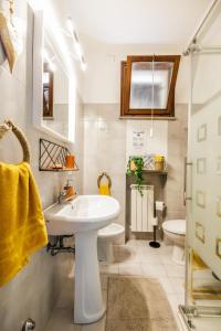 a white bathroom with a sink and a toilet at Appartamento Dolce Casa 2 in  Monvalle 