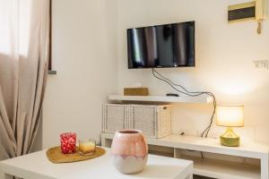 a living room with a desk with a tv on the wall at Appartamento Dolce Casa 2 in  Monvalle 