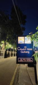 a sign on the side of a street at Cloud 7 Hotel Gulberg in Gulberg +6 photos