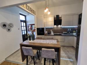 a kitchen with a dining room table and chairs at Apartman Beti in Opatija