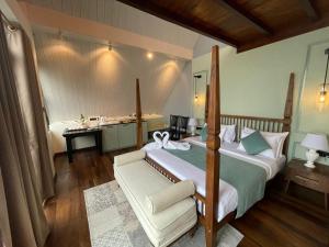 a bedroom with a bed and a desk in it at The Chapter in Nuwara Eliya