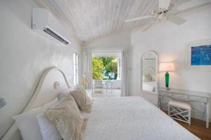 Un dormitorio blanco con una cama y un escritorio. en Waverly House townhouse, en Saint Peter