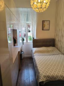 a small bedroom with a bed and a window at Apartman Beti in Opatija