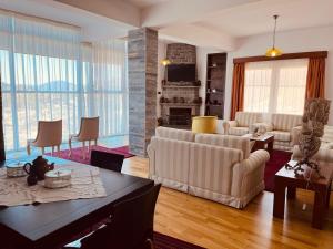 a living room with a couch and a table at Hotel Kanione in Çorovodë