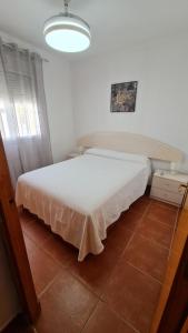 a bedroom with a large white bed in a room at Vaca House in El Puerto de Santa María