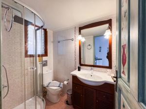 a bathroom with a sink and a toilet and a mirror at Villa Eleni Seaside Apartments in Plataniás +42 photos