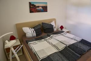 a bed with two pillows and a blanket on it at Bruno in Barušić +15 photos