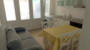 a living room with a couch and a table and a kitchen at Seaview apartment Lukić in Supetar