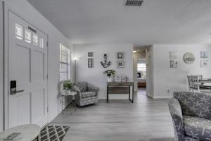 a living room with two chairs and a table at Coquina Cabana with fenced yard and adorable decor in South Daytona