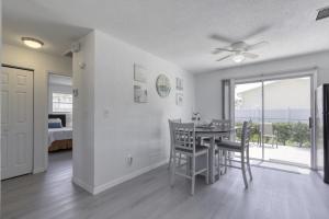 a dining room with a table and chairs and a bedroom at Coquina Cabana with fenced yard and adorable decor in South Daytona