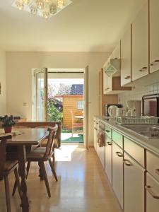 a kitchen with a table and a dining room at Bernhard Schmidt-Gasse in Gmunden