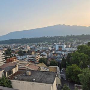 a city with buildings and a mountain in the background at Studio 181 Albion Residence Beautiful view and pool! in Aix-les-Bains