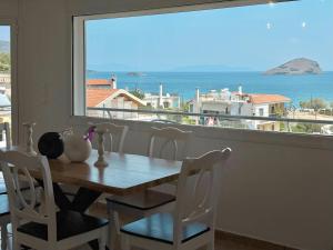 a dining room table with a view of the ocean at Seaview Complex with Pool in Porto Rafti