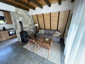 a living room with a couch and a stove at Zminica Lake House in Žabljak