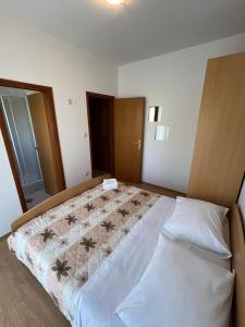 a bedroom with a large bed in a room at Economy room with kitchenette in Grebaštica +2 photos