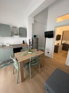 a kitchen and dining room with a table and chairs at Nicolas Apartments in Reggio Calabria