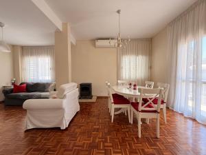 a living room with a table and chairs and a couch at Green Door 3bdr flat City Centre in Nicosia