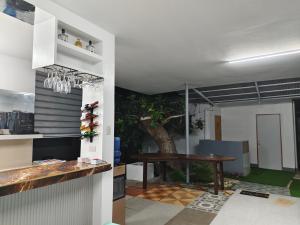 a dining room with a table and a tree at Papong Guest House in Puerto Princesa City