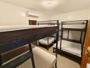 a room with two bunk beds in a room at Papong Guest House in Puerto Princesa City