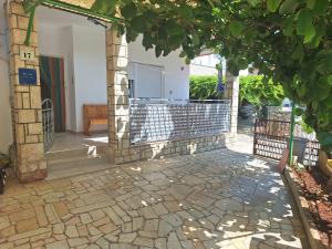 a patio with a gate and a stone walkway at Apartments Margareta in Novigrad Istria