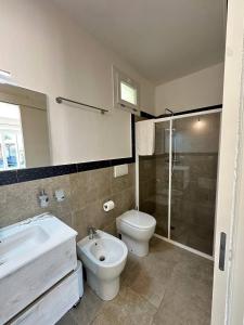 a bathroom with a sink and a toilet and a shower at Agricampeggio Tenuta Ferrario in Baia Verde +53 photos