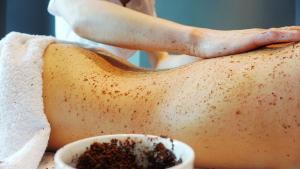 a person laying on a table with a towel at Schuchmann Wines Ch&acirc;teau,Villas & SPA in Tʼelavi