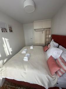 a bedroom with a large bed with towels on it at Belmare Bursztynowy Zakątek in Międzyzdroje +11 photos