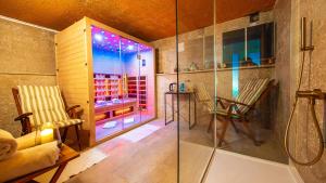 a bathroom with a shower and a table and chairs at La casa di Marko Sea View Apartments in Rabac