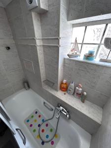 a bathroom with a bath tub with a sink at A-CLASS APARTMENT,near the sea & Patras University in Patra +25 photos