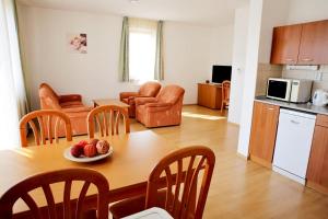 a kitchen and living room with a table and chairs at Apartmány Nový Svět in Třeboň II