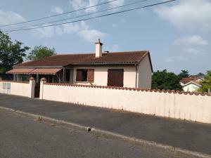 a white house behind a white fence at AïnaPat in Carmaux