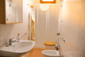 a bathroom with a sink and a toilet at Trulli al Chiaro di Luna in Putignano