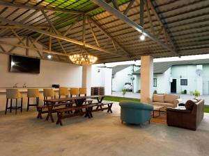 a large living room with a table and chairs at The Emerald Apartments Ibex Meanwood in Lusaka