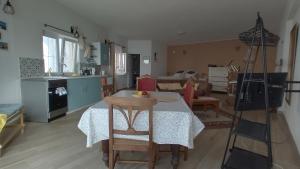 a kitchen and living room with a table and chairs at Studio Rocha Carvoeiro- Open Space in Carvoeiro