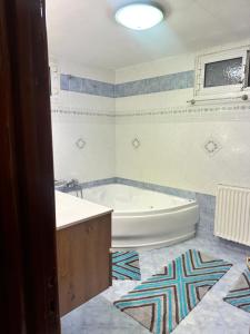 a bathroom with a tub and a sink and a bath tub at BLUE PANORAMA CRYSTAL with Amazing Sea View in Makri +65 photos