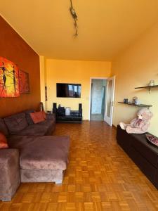 a living room with a couch and a teddy bear at B&b Bamby in Turin