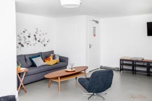 a living room with a couch and a table at L Escale in Ports