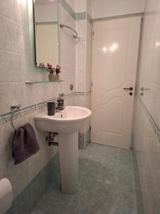 a bathroom with a sink and a mirror and a door at Panorama Villa in Plátanos +28 photos