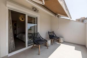 two chairs sitting on a balcony with a bedroom at Guesthouse Rooms Split in Split
