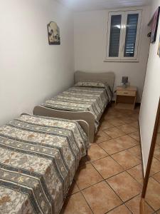 A bed or beds in a room at Tana Dell'Orso