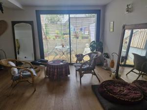 a living room with a table and chairs at Ananda in Le Mans +1 photo